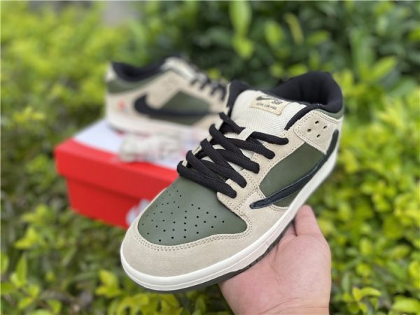 Olive Travis Scotts PlayStation Nike Dunk Low sneaker on hand